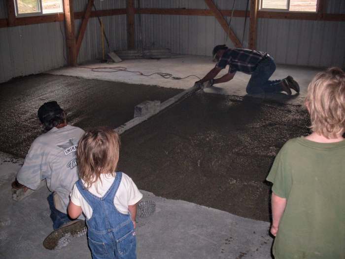 The men don't have to use a lot of muscle with this screed, as it is a power screed, and shakes the concrete into place. But they do need to be watchful and consistent, or the concrete may wind up slightly humpy.