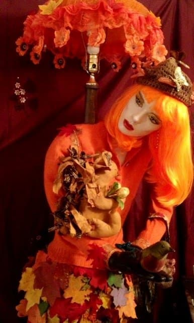 Here is my Harvest Maiden full body mannequin floor lamp. I created the squirrel from my primitive folk art design. Also, I designed her arms which are poseable. All clothing has been repurposed or designed by me.