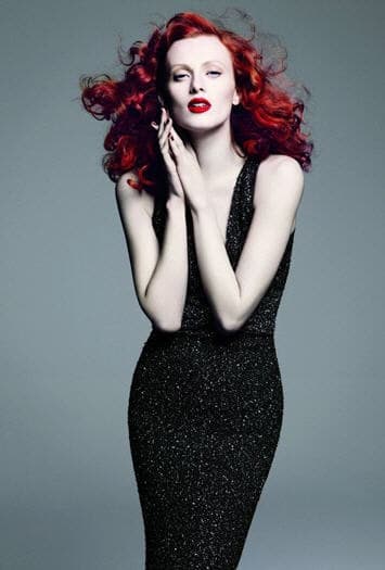 St John advertisement with glamorous red head wearing a black evening gown