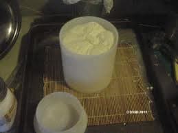 Spoon into a 2-pound mold. Place a cheese board in a shallow draining pan. Top the board with a cheese mat, followed by cheese filled mold.