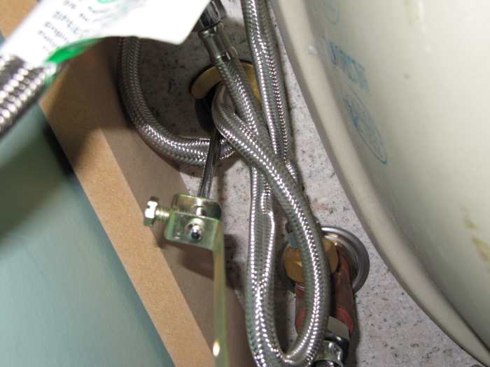Underside of my bathroom vanity looking up at the bottom of the taps. This is a great reason to use a basin wrench when doing a job like this.