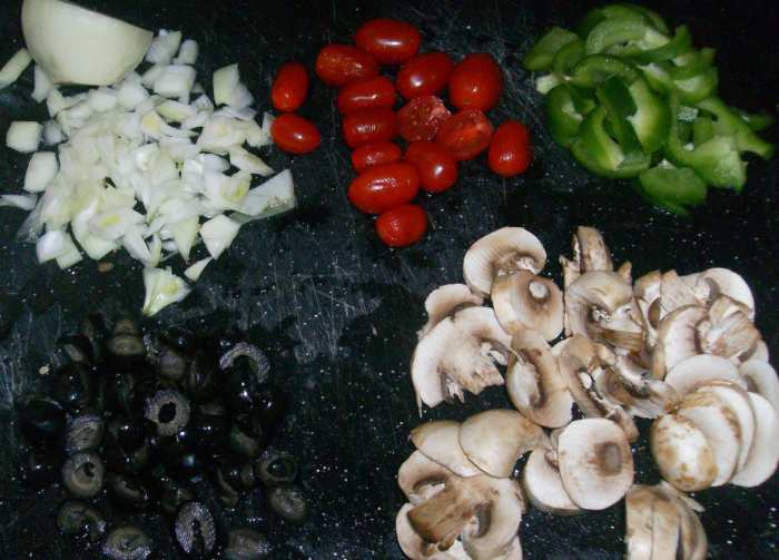 Get some of the family busy chopping vegetables while others mix up the crust and sauce. Don't forget to grate the mozzarella cheese!