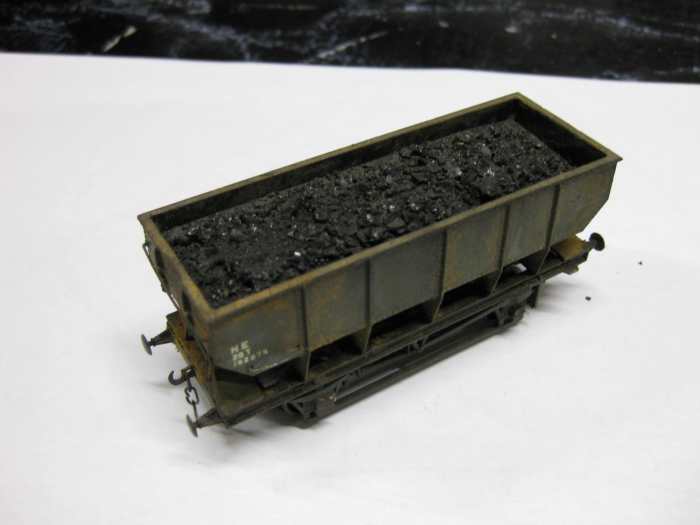 This is one of my own re-worked Dapol 21 ton LNER steel-built mineral hoppers with de-mountable load. Basically 2.5mm plastic card, layered, painted, PVA-spread, sprinkled with real coal granules. Raised to height with plastic blocks added to ends
