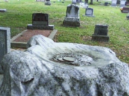 The top of the tomb stone has a curved well that appears as if a ball could have rested here.