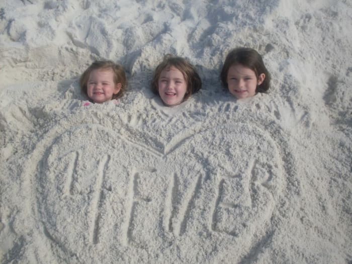 Chloe, Audrie, and Isabell say, "We don' need no stinkin' beach chairs!"