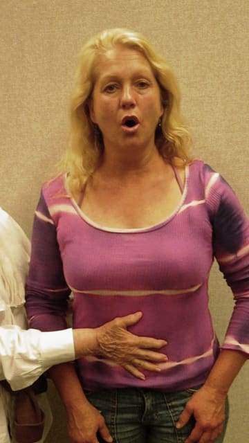 Inhale by inflating the lower ribcage and abdominal wall. Do this simultaneously. Notice where my hand is placed in the photo. Breathe through the nose to inhale and exhale slowly through the mouth. Use a hissing sound.