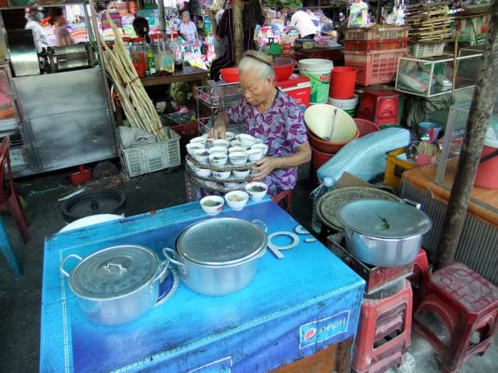 My travel to Vietnam: Preparing to get her stall ready for business at Dong Ba market in Hue