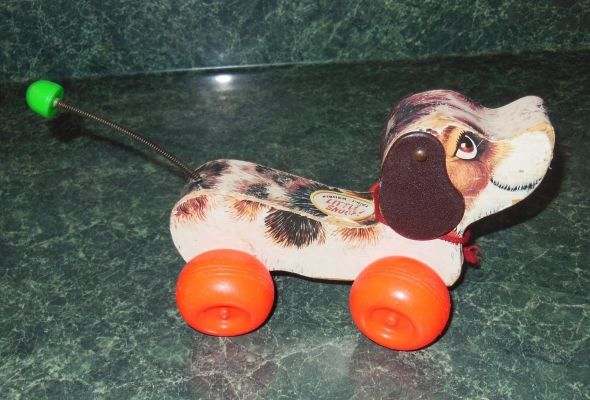 Pull Toys were a favorite for many! He should have a little red shoe hanging from his mouth but it's missing on this one.