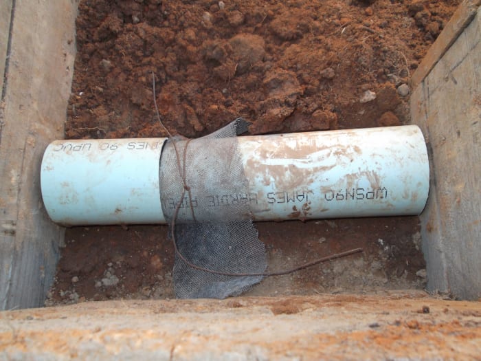 We inserted a piece of plumbing pipe, but cut it into two piece to allow metal fly screen to be inserted and held in place by the wall itself.