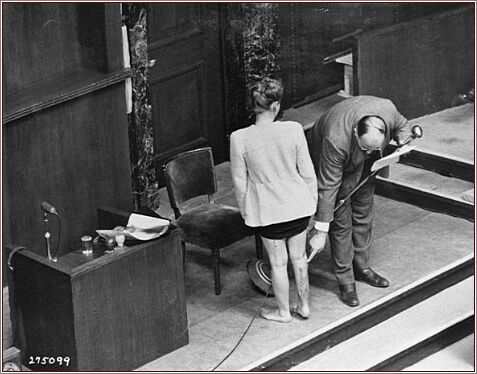 At the Nuremberg "Doctors' Trial," a doctor presents the scars on the leg of a Polish survivor who endured sulfanilamide experiments at the Ravensbrück concentration camp.