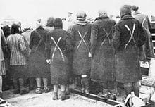 Female prisoners gathered when the Red Cross arrive to Ravensbrcck in April 1945. The white paint marks shows they are prisoners.