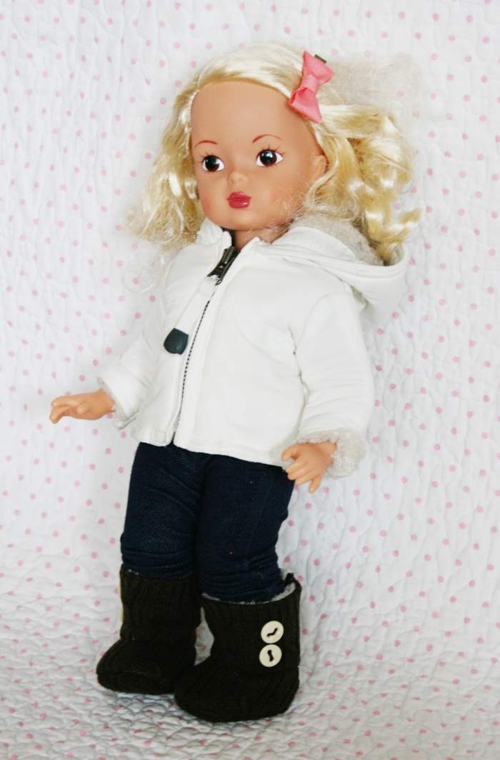 blonde doll with black pants white hoodie and tan UGGs