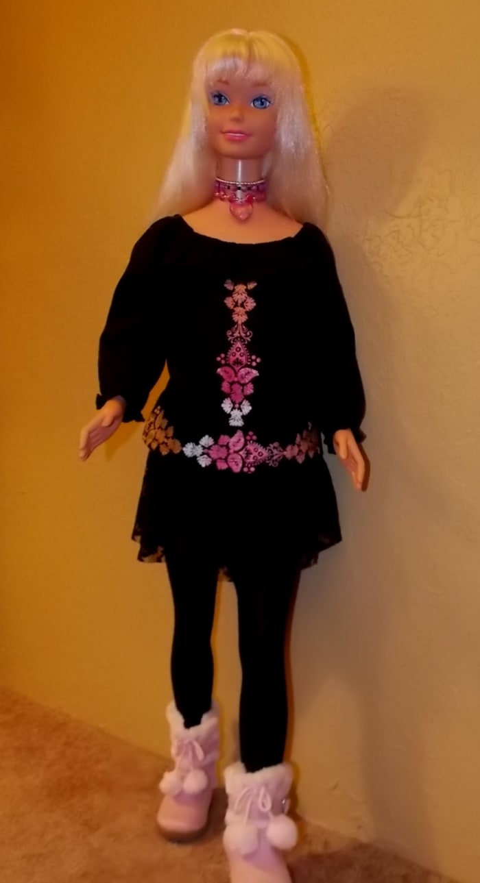 Barbie doll wearing black outfit with pink Uggs