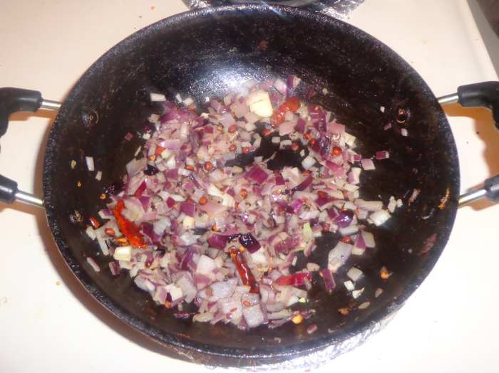 Chopped onions are added inside the oil for frying. Once onion has become golden brown, add ginger garlic paste.