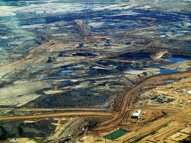 Alberta tar sands. Oil and tar sands are strip mined or extracted in the open pit method.