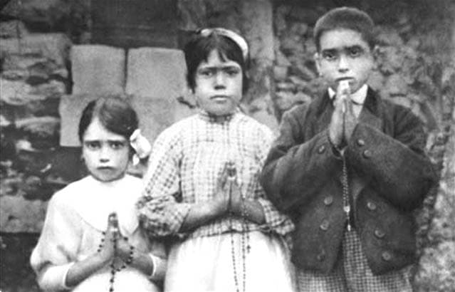 A 1917 photo of the real visionaries of Fatima: Jacinta (age 7), Lucia (age 10) and Francisco (age 9)