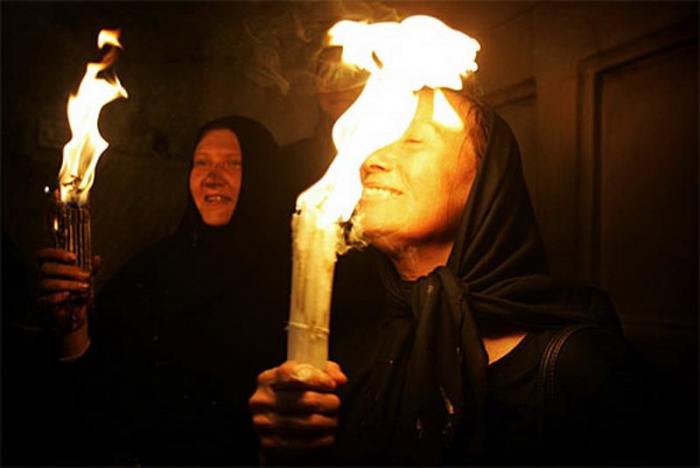 Holy fire. The fire is lit on to bundle of 33 candles. Pilgrims claim the Holy Fire has amazing properties it does not burn their hair, faces, clothes or anything else during the first 33 minutes of its appearance.
