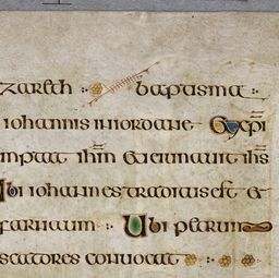 Page of text with illuminated letters at beginning of sentences and interlinear art.