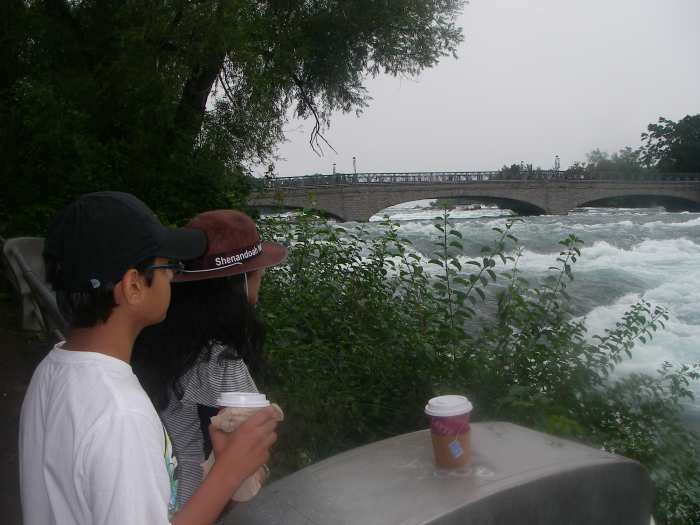 My children taking a rest during the hike. You can see the river turning into a rapid. Note that my daughter is pridefully wearing her Shenandoah National Park Rangers hat.