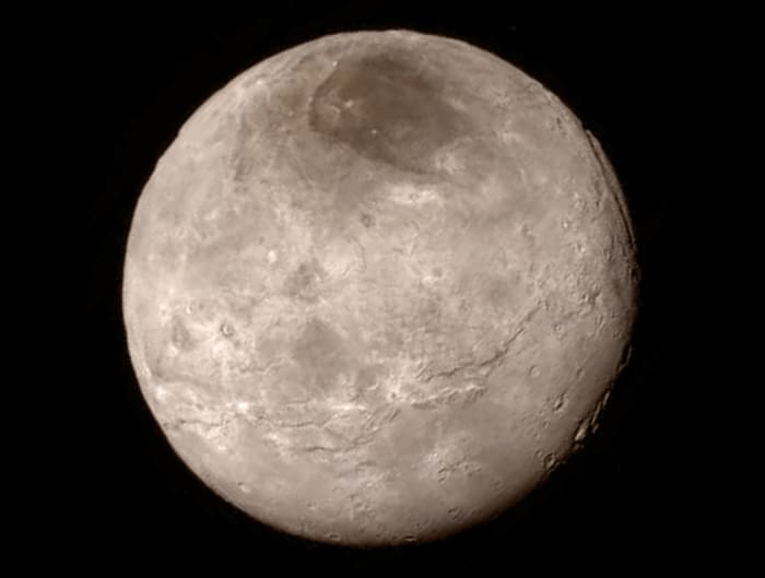 July 13 photo of Charon shows a younger, more varied landscape than we could've hoped for, with canyons many miles deep! The dark patch at the top is called "MORDOR."