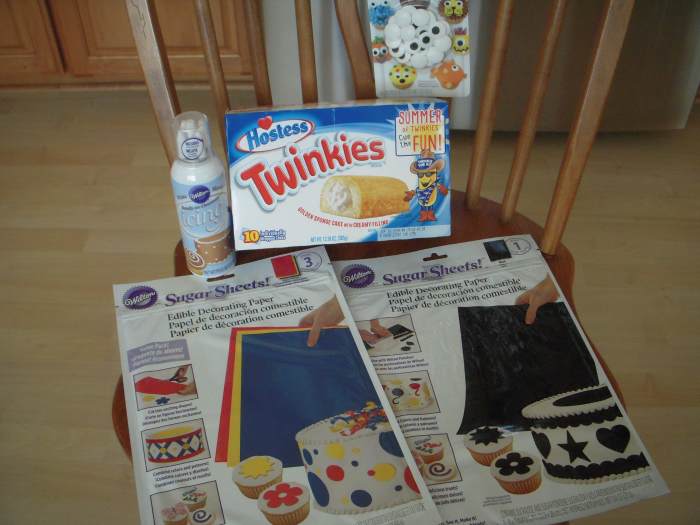 Pictured: Hostess Twinkies, Wilton Sugar Sheets (blue and black,) icing in a can, Wilton sugar eyes (large size.)