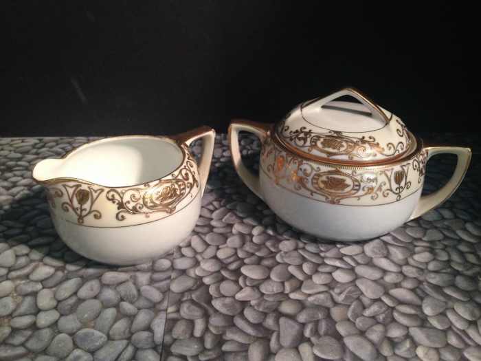 One set of cream and sugar made by the Nortake Company with the 24k gold hand painted Christmas Ball Pattern.