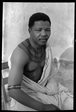 Eli Weinberg, Nelson Mandela portrait wearing traditional beads and a bedspread. Hiding out from the police during his period as the “black pimpernel,” 1961. Courtesy of IDAFSA