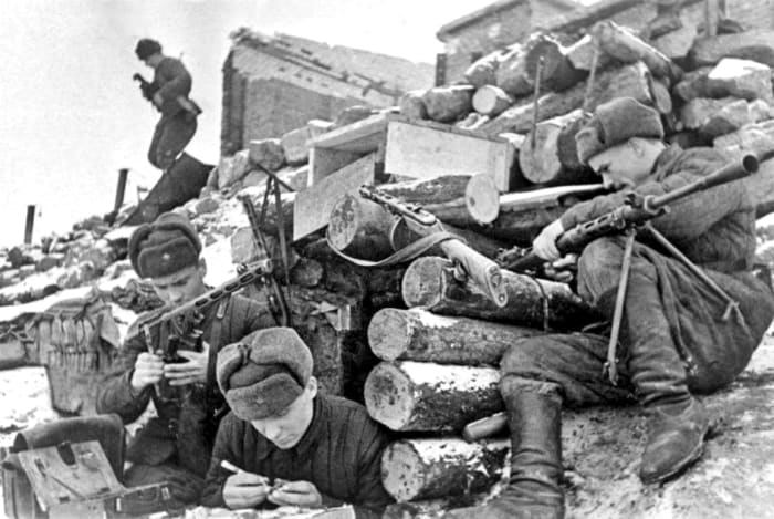 Soviet troops taking time to clean their weapons during a lull in the fighting at Stalingrad.