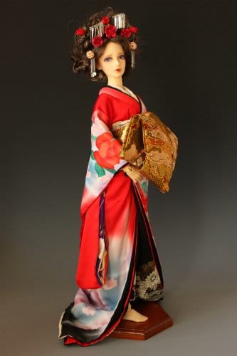 This doll shows the kimono of the "oiran" or courtesan, of the Edo period. During this time, prostitution was legal, but heavily regulated, with prostitutes being confined to certain districts known as the "pleasure quarters".