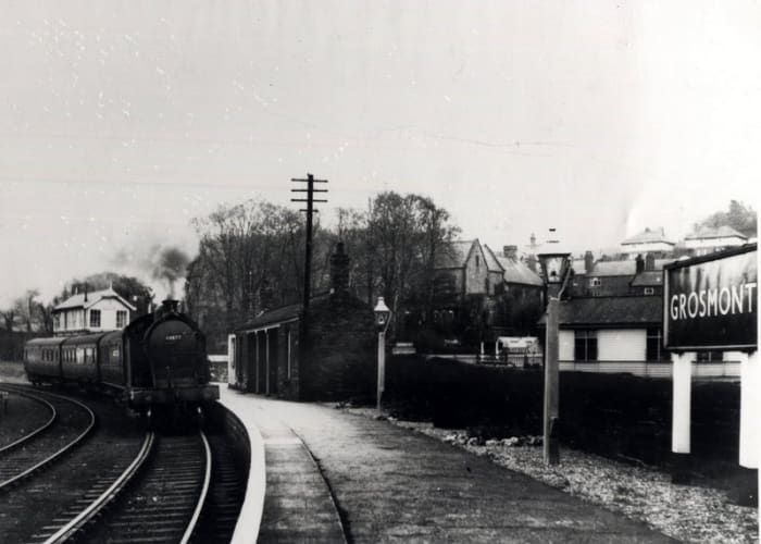 A Class A8 4-6-2 tank engine enters from Whitby. The platform shelter is still there, built by the NER in the mid-1860s. Trains to and from York came through the far platforms. Plinth-based signal cabin behind the engine was demolished mid-1980s