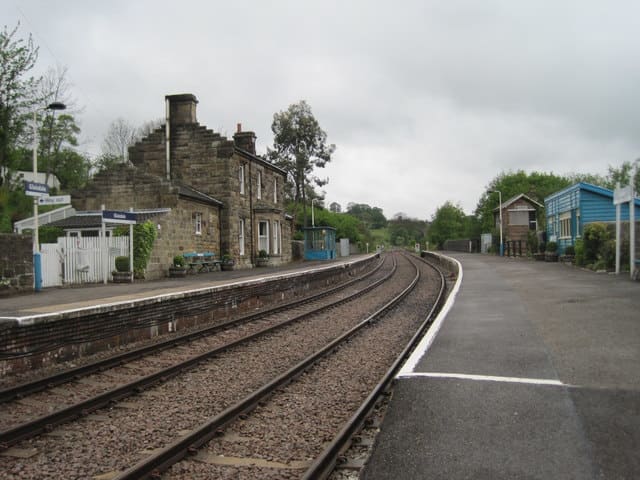 Glaisdale Station looking west, with the Station Master's house, offices and facilities on the 'Up' platform. A waiting shelter in the earlier NER building style stands midway on the 'Down' platform near the former signal cabin
