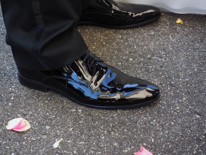 Slice a potato in two and use one half to go over the entire surface of your shoe. Wait a few minutes and buff well. It really works!