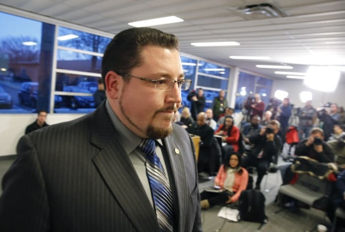 Ferguson Mayor James W. Knowles leaves a news conference after reading a statement on Wednesday.