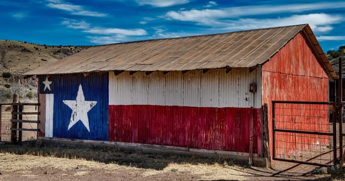 Not exactly a barn quilt, but they've created a mural with the Texas flag on this small barn.