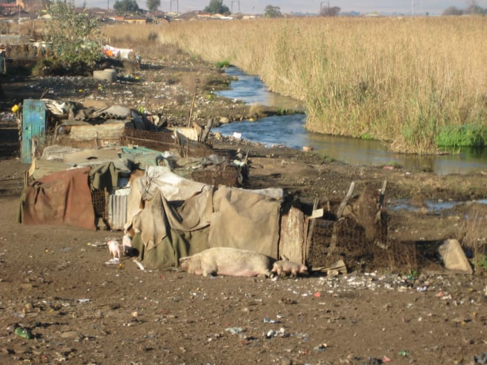 In Soweto, Kliptown Sqatter Camp, Southwest of Johannesburg, and this is one of the of the 45,000-person slums