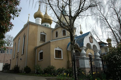By entering the church together, the Greek Orthodox bride and groom make their marriage pledge - no vows are recited.