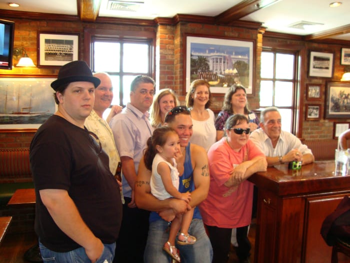 Family members get together. From left, top row, are Brandon Revels, Martin Torpey, Kieran Hogan, Natashah Revels Quinlan, Catherine Torpey, Beth Torpey Revels, and, first row, John Hogan IV (holding daughter, Valerie), Michelle Hogan, Michael Hogan