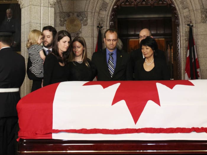 Olivia Chow and family members stand before the coffin containing her husband and Canada's leader of the Opposition Jack Layton in the Center Block of Parliament Hill in Ottawa August 24, 2011.