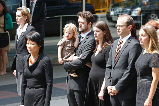 Olivia Chow walks towards Roy Thomson Hall in the funeral procession with Mike and Sarah Layton and their families, August 27, 2011.