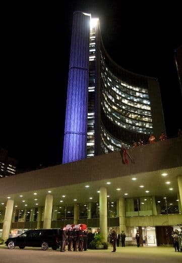 The funeral cortege carrying the body of federal NDP leader Jack Layton arrives from Parliament Hill at Toronto's city hall on Wednesday, August 25, 2011.