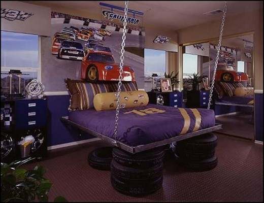 With actual tires under the bed & a car popping out of the wall this room looks amazing! That bed is pretty wild too.