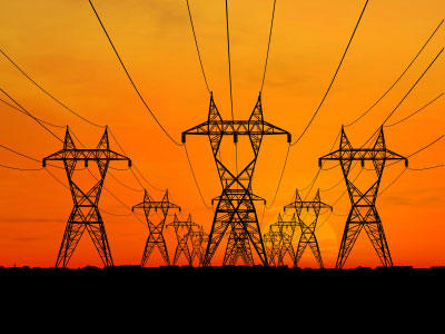 High voltage electrical lines such as these transmit alternating current from generating stations to consumers nationwide.