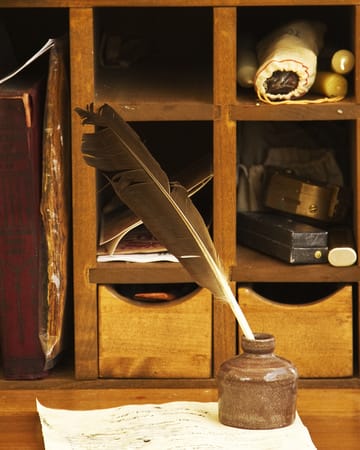 A quill and inkwell. Though this desk setting was either for an officer or in a home, the quill and inkwell are accurate for a common infantryman's writing tools.
