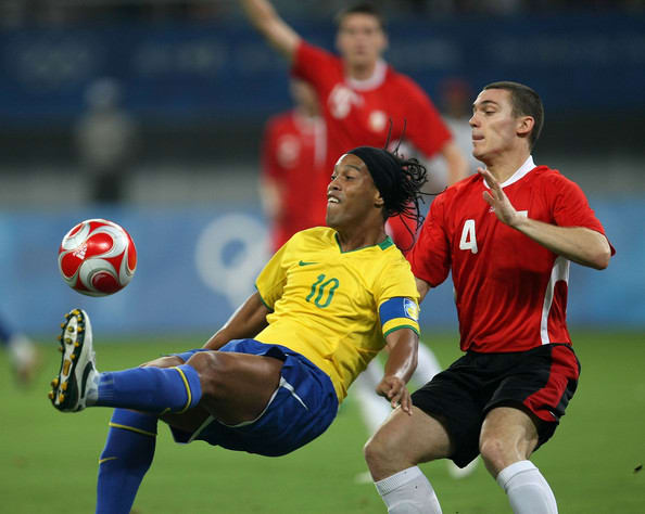 Brazil's Ronaldinho (10) and Belgium's Thomas Vermaelen in action during the teams' bronze medal match on Aug, 22. 2008. Brazil defeated Belgium twice, including a 3-0 result to win the bronze medal.