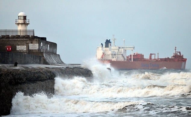 Looking past the South Gare beacon at a departing tanker - there is a steady flow of tankers and ore ships to Teesmouth, you'll see the pilot boats ploughing in and out through the surf. The beacon tower''s been replaced, by a pair of masts
