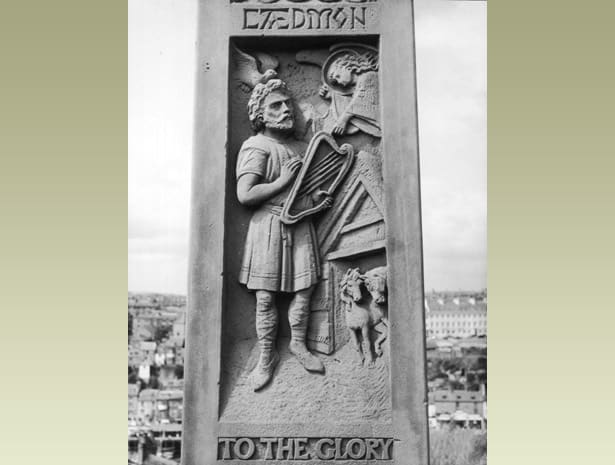 A panel of the cross showing the herdsman Caedmon with his lyre. He was a Celtic herdsman at Whitby Abbey in its early days