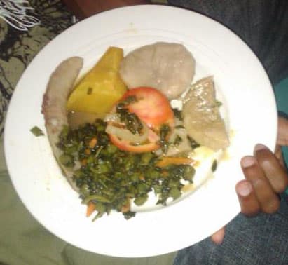 A typical Jamaican-Rastafarian vegetarian food with Boiled Yam, Banana, Dumpling with tomato and callaloo