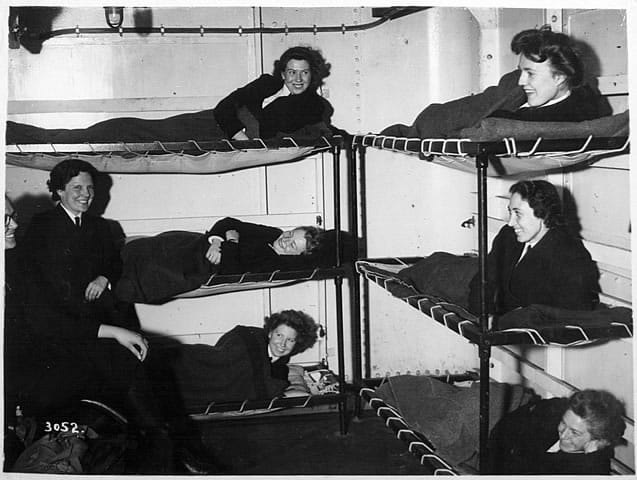 Wrens billeted to bunks in a naval base. It must have all felt so different to home but look at their smiles. Life was an adventure.