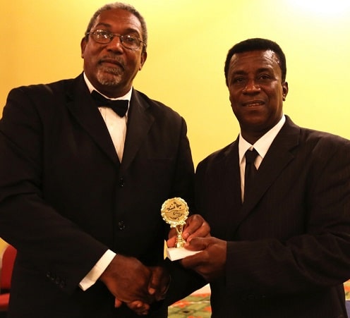 Former Leeward Islands Cricket Association (LICA) President and West Indies Cricket Board (WICB) Director Mr. Gregory Shillingford presents an award to Willett in June, 2014. Willett is on the right. – (WICB Media photo)