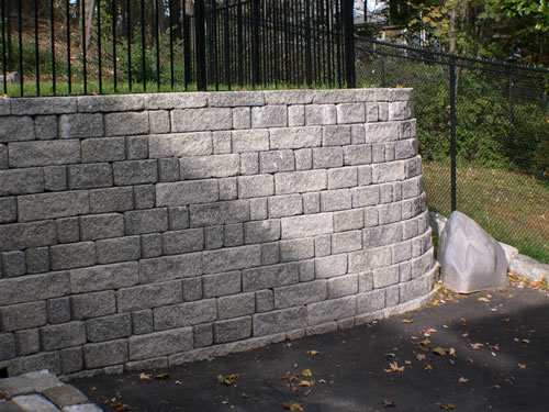 There are many types of retaining walls, this is a masonry stone retaining wall, these types of retaining walls last for a very long time, when they are well build, like the one here, but they cost a lot more than other types of retaining walls.